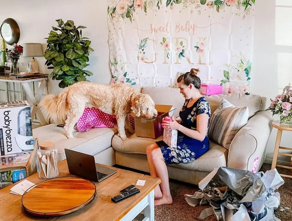 mom opening a gift during virtual baby shower