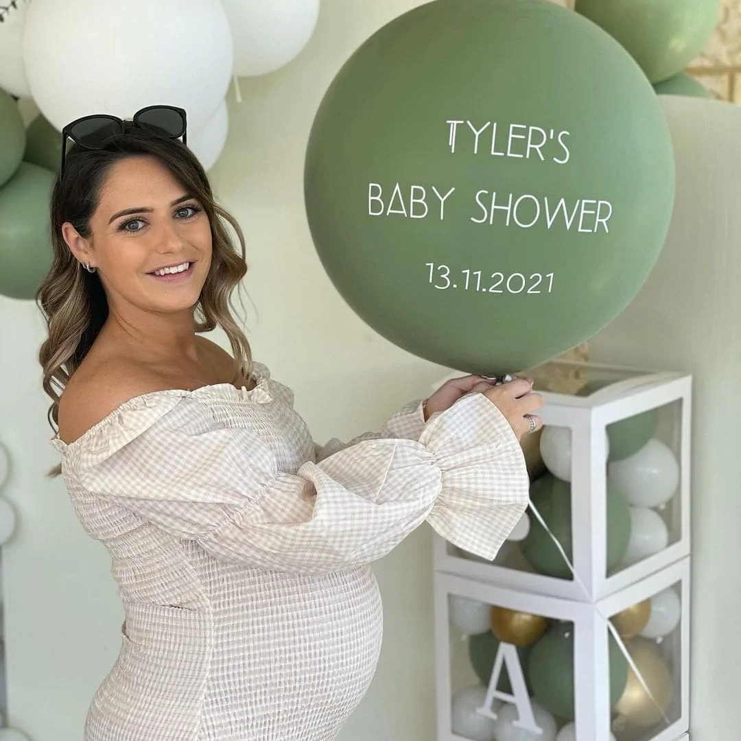 gender neutral in person mom holding a balloon | WebBabyShower